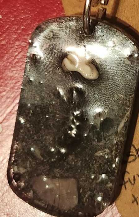 Custom resin memorial tag holding a pet's keepsakes